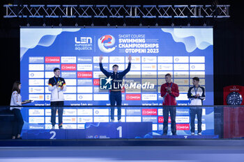 2023-12-06 - Tomac Mewen of France, Braunschweig Ole of Germany, Mora Lorenzo of Italy and Bollin Thierry of Switzerland during the podium ceremony of Men’s 50m Backstroke at the LEN Short Course European Championships 2023 on December 6, 2023 in Otopeni, Romania - SWIMMING - LEN SHORT COURSE EUROPEAN CHAMPIONSHIPS 2023 - DAY 2 - SWIMMING - SWIMMING