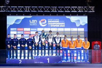 2023-12-06 - Team Italy, Team Great Britain and Team Netherlands during the podium ceremony for Men’s 4X50m Medley Relay at the LEN Short Course European Championships 2023 on December 6, 2023 in Otopeni, Romania - SWIMMING - LEN SHORT COURSE EUROPEAN CHAMPIONSHIPS 2023 - DAY 2 - SWIMMING - SWIMMING