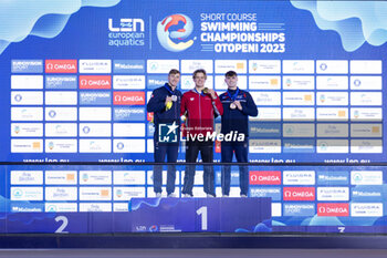 2023-12-06 - Ponti Noe of Switzerland, Grousset Maxime of France and Peters Jacob of Great Britain during the podium ceremony for Men’s 100m Butterfly at the LEN Short Course European Championships 2023 on December 6, 2023 in Otopeni, Romania - SWIMMING - LEN SHORT COURSE EUROPEAN CHAMPIONSHIPS 2023 - DAY 2 - SWIMMING - SWIMMING