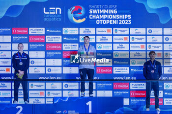 10/12/2023 - Mora Lorenzo of Italy, Greenbank Luke of Great Britain and Tomac Mewen of France during the podium ceremony for Men’s 200m Backstroke at the LEN Short Course European Championships 2023 on December 10, 2023 in Otopeni, Romania - SWIMMING - LEN SHORT COURSE EUROPEAN CHAMPIONSHIPS 2023 - DAY 6 - NUOTO - NUOTO