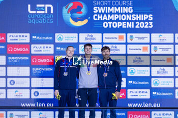 2023-12-10 - Mora Lorenzo of Italy, Greenbank Luke of Great Britain and Tomac Mewen of France during the podium ceremony for Men’s 200m Backstroke at the LEN Short Course European Championships 2023 on December 10, 2023 in Otopeni, Romania - SWIMMING - LEN SHORT COURSE EUROPEAN CHAMPIONSHIPS 2023 - DAY 6 - SWIMMING - SWIMMING