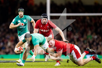 04/02/2023 - Bundee Aki of Ireland is tackled by Rhys Carré of Wales during the Six Nations 2023, rugby union match between Wales and Ireland on February 4, 2023 at Millenium Stadium in Cardiff, Wales - RUGBY - SIX NATIONS 2023 - WALES V IRELAND - 6 NAZIONI - RUGBY
