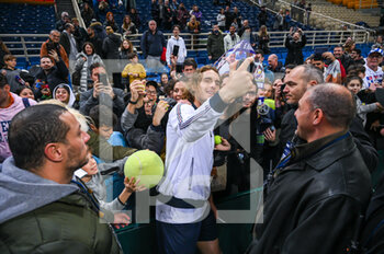 2023-02-05 - STEFANOS TSITSIPAS of Greece taking selfies with fans after winning the game during day two of the Davis Cup World Group I Play-off between Greece and Ecuador at Olympic Athletic Center of Athens 