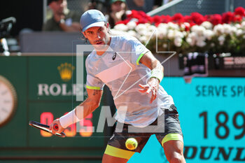 2023-05-05 - Borna Coric of Croatia in action against Carlos Alcaraz of Spain during the Mutua Madrid Open 2023, Masters 1000 tennis tournament on May 5, 2023 at Caja Magica in Madrid, Spain - TENNIS - MUTUA MADRID OPEN 2023 - INTERNATIONALS - TENNIS