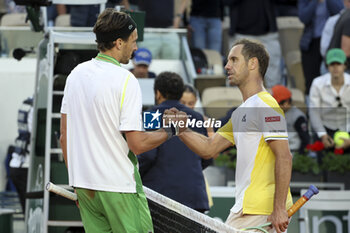 2023-05-30 - Arthur Rinderknech of France shakes hands with Richard Gasquet of France at the net after his first round victory during day 3 of the 2023 French Open, Roland-Garros 2023, second Grand Slam tennis tournament of the year, on May 30, 2023 at Stade Roland-Garros in Paris, France - TENNIS - ROLAND GARROS 2023 - WEEK 1 - INTERNATIONALS - TENNIS