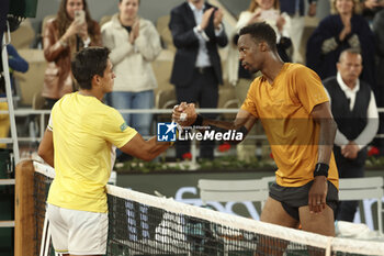 2023-05-31 - Winner Gael Monfils of France (right) shakes hands with Sebastian Baez of Argentina after winning his first round match during day 3 of the 2023 French Open, Roland-Garros 2023, second Grand Slam tennis tournament of the year, on May 30, 2023 at Stade Roland-Garros in Paris, France - TENNIS - ROLAND GARROS 2023 - WEEK 1 - INTERNATIONALS - TENNIS