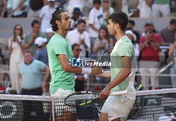 2023-06-04 - Carlos Alcaraz of Spain shakes hands with Lorenzo Musetti of Italy (left) after his victory during day 8 of the 2023 French Open, Roland-Garros 2023, second Grand Slam tennis tournament of the year, on June 4, 2023 at Stade Roland-Garros in Paris, France - TENNIS - ROLAND GARROS 2023 - WEEK 1 - INTERNATIONALS - TENNIS