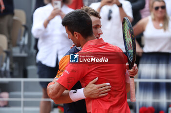 2023-06-11 - Winner Novak Djokovic of Serbia hugs Casper Ruud of Norway during the Men's Singles Final at the French Open 2023, Roland-Garros 2023, Grand Slam tennis tournament, on June 11, 2023 at Stade Roland-Garros in Paris, France - TENNIS - ROLAND GARROS 2023 - WEEK 2 - INTERNATIONALS - TENNIS