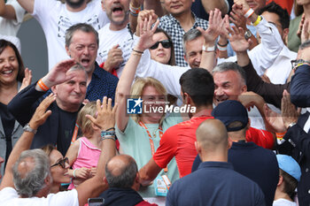 2023-06-11 - Novak Djokovic of Serbia celebrates with his parents Dijana Dokovic and Srdjan Djokovic after his victory in the Men's Singles Final against Casper Ruud of Norway at the French Open 2023, Grand Slam tennis tournament, on June 11, 2023 at Stade Roland-Garros in Paris, France - TENNIS - ROLAND GARROS 2023 - WEEK 2 - INTERNATIONALS - TENNIS