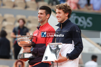 2023-06-11 - Winner Novak Djokovic of Serbia, Finalist Casper Ruud of Norway during the trophy ceremony following the Men's Singles Final at the French Open 2023, Roland-Garros 2023, Grand Slam tennis tournament, on June 11, 2023 at Stade Roland-Garros in Paris, France - TENNIS - ROLAND GARROS 2023 - WEEK 2 - INTERNATIONALS - TENNIS