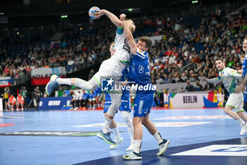 2024-01-11 - Nejc Cehte (Slovenia) in action against Trondur Mikkelsen (Faore Islands) during the Men’s EHF Euro 2024 match between Slovenia vs. Faroe Islands at the Mercedes-Benz Arena in Berlin, Germany - MEN'S EHF EURO 2024 - SLOVENIA VS FAROE ISLAND - HANDBALL - OTHER SPORTS