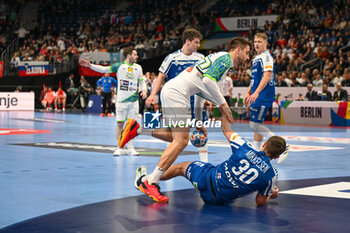 2024-01-11 - Foul of Trondur Mikkelsen (Faore Islands) on Nejc Cehte (Slovenia) during the Men’s EHF Euro 2024 match between Slovenia vs. Faroe Islands at the Mercedes-Benz Arena in Berlin, Germany - MEN'S EHF EURO 2024 - SLOVENIA VS FAROE ISLAND - HANDBALL - OTHER SPORTS