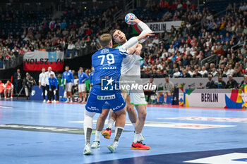 2024-01-11 - Nejc Cehte (Slovenia) in action against Teis Horn Rasmussen (Faore Islands) during the Men’s EHF Euro 2024 match between Slovenia vs. Faroe Islands at the Mercedes-Benz Arena in Berlin, Germany - MEN'S EHF EURO 2024 - SLOVENIA VS FAROE ISLAND - HANDBALL - OTHER SPORTS