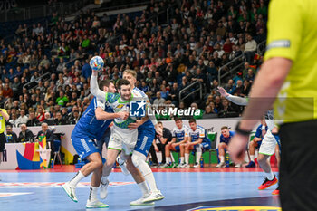 2024-01-11 - Miha Zarabec (Slovenia) in action against Helgi Hildarson Hoydal (Faore Islands) during the Men’s EHF Euro 2024 match between Slovenia vs. Faroe Islands at the Mercedes-Benz Arena in Berlin, Germany - MEN'S EHF EURO 2024 - SLOVENIA VS FAROE ISLAND - HANDBALL - OTHER SPORTS