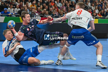 2024-01-13 - Sander Sagosen (Norway) in action against Patur Mikkjalsson (Faore Islands) and Teis Horn Rasmussen (Faore Islands) during the Men’s EHF Euro 2024 match between Faroe Islands vs.Norway at the Mercedes-Benz Arena in Berlin, Germany - MEN'S EHF EURO 2024 - FAROE ISLANDS VS NORWAY - HANDBALL - OTHER SPORTS