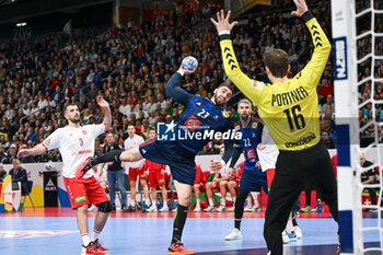 2024-01-14 - Ludovic Fabregas (France) in action against Nikola Portner (Swiss) that he saves the ball during the Men’s EHF Euro 2024 match between Swiss vs. France at the Mercedes-Benz Arena in Berlin, Germany - MEN'S EHF EURO 2024 - SWITZERLAND VS FRANCE - HANDBALL - OTHER SPORTS