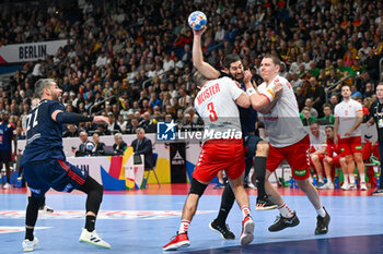 2024-01-14 - Nikola Karabatic (France) in action against Lucas Meister (Swiss) during the Men’s EHF Euro 2024 match between Swiss vs. France at the Mercedes-Benz Arena in Berlin, Germany - MEN'S EHF EURO 2024 - SWITZERLAND VS FRANCE - HANDBALL - OTHER SPORTS