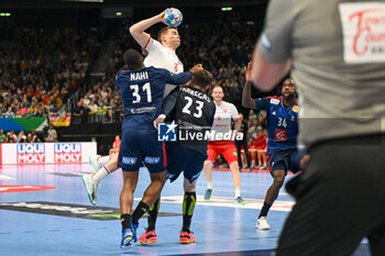 2024-01-14 - Manuel Zehnder (Swiss) in action against Dylan Nahi (France) and Ludovic Fabregas (France) during the Men’s EHF Euro 2024 match between Swiss vs. France at the Mercedes-Benz Arena in Berlin, Germany - MEN'S EHF EURO 2024 - SWITZERLAND VS FRANCE - HANDBALL - OTHER SPORTS