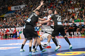 2024-01-14 - Marko Mitev (North Macedonia) in action against Sebastian Heymann (Germany) and Christoph Steinert (Germany) during the Men’s EHF Euro 2024 match between North Macedonia vs. Germany at the Mercedes-Benz Arena in Berlin, Germany - MEN'S EHF EURO 2024 - NORTH MACEDONIA VS GERMANY - HANDBALL - OTHER SPORTS