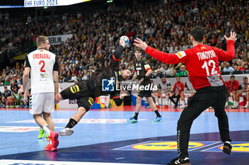 2024-01-14 - Jannik Kohlbacher (Germany) in action against Martin Tomovski (North Macedonia) during the Men’s EHF Euro 2024 match between North Macedonia vs. Germany at the Mercedes-Benz Arena in Berlin, Germany - MEN'S EHF EURO 2024 - NORTH MACEDONIA VS GERMANY - HANDBALL - OTHER SPORTS