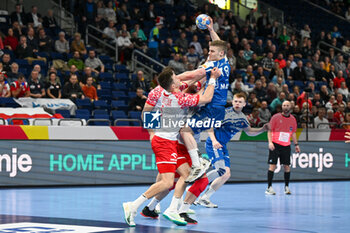 2024-01-15 - Oli Mittun (Faore Islands) in action against Michal Olejniczak (Poland) during the Men’s EHF Euro 2024 match between Poland vs. Faroe Islands at the Mercedes-Benz Arena in Berlin, Germany - MEN'S EHF EURO 2024 - POLAND VS FAROE ISLANDS - HANDBALL - OTHER SPORTS