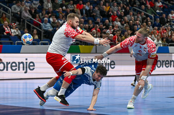 2024-01-15 - Maciej Gebala (Poland) in action against Elias Ellefsen a Skipagotu (Faore Islands) during the Men’s EHF Euro 2024 match between Poland vs. Faroe Islands at the Mercedes-Benz Arena in Berlin, Germany - MEN'S EHF EURO 2024 - POLAND VS FAROE ISLANDS - HANDBALL - OTHER SPORTS