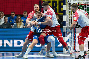 2024-01-15 - Teis Horn Rasmussen (Faore Islands) in action against Maciej Gebala (Poland) and Kamil Syprzak (Poland) during the Men’s EHF Euro 2024 match between Poland vs. Faroe Islands at the Mercedes-Benz Arena in Berlin, Germany - MEN'S EHF EURO 2024 - POLAND VS FAROE ISLANDS - HANDBALL - OTHER SPORTS