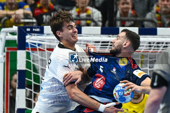 2024-01-16 - Julian Koster (Germany) in action against Nedim Remili (France) during the Men’s EHF Euro 2024 match between France vs. Germany at the Mercedes-Benz Arena in Berlin, Germany - MEN'S EHF EURO 2024 - FRANCE VS GERMANY - HANDBALL - OTHER SPORTS