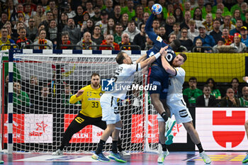 2024-01-16 - Dika Mem (France) in action against Kai Hafner (Germany) and Johannes Golla (Germany) during the Men’s EHF Euro 2024 match between France vs. Germany at the Mercedes-Benz Arena in Berlin, Germany - MEN'S EHF EURO 2024 - FRANCE VS GERMANY - HANDBALL - OTHER SPORTS