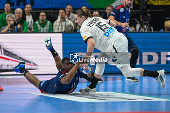 2024-01-16 - Dika Mem (France) recovers the ball from Juri Knorr (Germany) during the Men’s EHF Euro 2024 match between France vs. Germany at the Mercedes-Benz Arena in Berlin, Germany - MEN'S EHF EURO 2024 - FRANCE VS GERMANY - HANDBALL - OTHER SPORTS