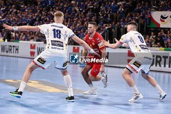 2024-01-14 - Radojica Cepic of Montenegro and Ellidi Snaer Vidarsson, Elvar Jonsson of Iceland during the Men's Euro 2024, Group C handball match between Montenegro and Iceland on January 14, 2024 at Olympiahalle in Munich, Germany - HANDBALL - MEN'S EHF EURO 2024 - MONTENEGRO V ICELAND - HANDBALL - OTHER SPORTS