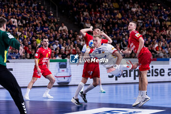 2024-01-14 - Ellidi Vidarsson of Iceland and Vasilije Kaludjerovic, Radojica Cepic of Montenegro during the Men's Euro 2024, Group C handball match between Montenegro and Iceland on January 14, 2024 at Olympiahalle in Munich, Germany - HANDBALL - MEN'S EHF EURO 2024 - MONTENEGRO V ICELAND - HANDBALL - OTHER SPORTS
