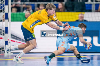 2024-01-15 - Luc Steins of The Netherlands is challenged by Jonathan Carlsbogard of Sweden during the Men's EHF Euro 2024, Group E handball match between Sweden and Netherlands on January 15, 2024 at SAPP Arena in Mannheim, Germany - HANDBALL - MEN'S EHF EURO 2024 - SWEDEN V NETHERLANDS - HANDBALL - OTHER SPORTS