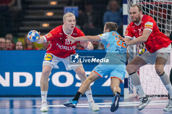 2024-01-17 - Luc Steins of The Netherlands is challenged by Magnus Saugstrup Jensen and Henrik Mollgaard Jensen of Denmark during the Men's EHF Euro 2024, Group E handball match between Denmark and Netherlands on January 17, 2024 at Barclays Arena in Hamburg, Germany - HANDBALL - MEN'S EHF EURO 2024 - DENMARK V NETHERLANDS - HANDBALL - OTHER SPORTS