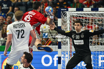 2024-01-18 - Miklos Rosta (Hungary) in action against Constantin Mostl (Austria) during the Men’s EHF Euro 2024 match between Hungary vs.Austria at the Lanxess Arena in Berlin, Cologne - MEN'S EHF EURO 2024 - HUNGARY VS AUSTRIA - HANDBALL - OTHER SPORTS
