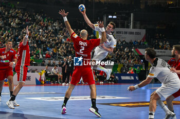 2024-01-18 - Adrian Sipos (Hungary) in action against Mykola Bilyk (Austria) during the Men’s EHF Euro 2024 match between Hungary vs.Austria at the Lanxess Arena in Berlin, Cologne - MEN'S EHF EURO 2024 - HUNGARY VS AUSTRIA - HANDBALL - OTHER SPORTS