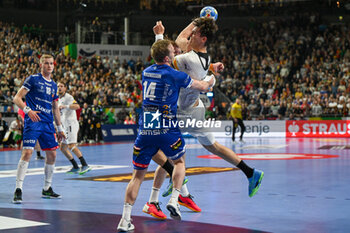2024-01-18 - Julian Koster (Germany) in action against Omar Ingi Magnusson (Iceland) during the Men’s EHF Euro 2024 match between Germany vs. Iceland at the Lanxess Arena in Berlin, Cologne - MEN'S EHF EURO 2024 - GERMANY VS ICELAND - HANDBALL - OTHER SPORTS