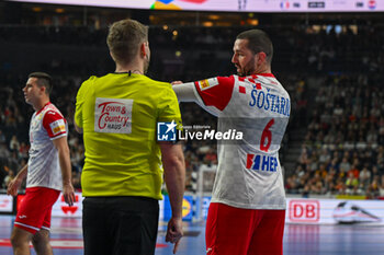 2024-01-18 - Mario Sostaric (Croatia) shows his disappointment with the referee during the Men’s EHF Euro 2024 match between France vs. Croatia at the Lanxess Arena in Berlin, Cologne - MEN'S EHF EURO 2024 - FRANCE VS CROATIA - HANDBALL - OTHER SPORTS