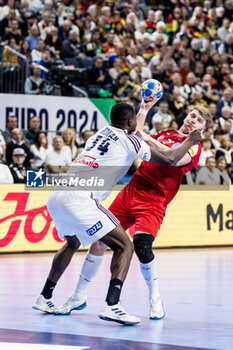 2024-01-22 - Karl Konan of France and Lukas Hutecek of Austria during the Men's EHF Euro 2024, Main Round, handball match between France and Austria on January 22, 2024 at Lanxess-Arena in Cologne, Germany - HANDBALL - MEN'S EHF EURO 2024 - FRANCE V AUSTRIA - HANDBALL - OTHER SPORTS