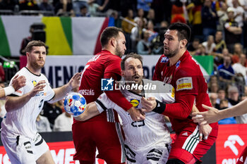 2024-01-22 - Kai Häfner of Germany and Bendeguz Boka (7), Bence Banhidi (27) of Hungary during the Men's EHF Euro 2024, Main Round, handball match between Germany and Hungary on January 22, 2024 at Lanxess-Arena in Cologne, Germany - HANDBALL - MEN'S EHF EURO 2024 - GERMANY V HUNGARY - HANDBALL - OTHER SPORTS
