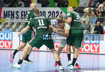 2024-01-26 - Dean Bombac of Slovenia and Patrik Ligetvari, Gabor Ancsin of Hungary during the Men's EHF Euro 2024, Placement match 5/6, handball match between Hungary and Slovenia on January 26, 2024 at Lanxess-Arena in Cologne, Germany - HANDBALL - MEN'S EHF EURO 2024 - HUNGARY V SLOVENIA - HANDBALL - OTHER SPORTS