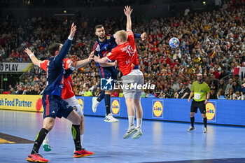 2024-01-28 - Nedim Remili (France) in action against Magnus SaugstrupJensen (Denmark) during 2nd and 1st place final of the Men’s EHF Euro 2024 match between France vs Denmark at the Lanxess Arena, Cologne, Germany - MEN'S EHF EURO 2024 - FINAL - FRANCE VS DENMARK - HANDBALL - OTHER SPORTS