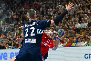2024-01-28 - Mathias Gidsel (Denmark) in action against Luka Karabatic (France) during 2nd and 1st place final of the Men’s EHF Euro 2024 match between France vs Denmark at the Lanxess Arena, Cologne, Germany - MEN'S EHF EURO 2024 - FINAL - FRANCE VS DENMARK - HANDBALL - OTHER SPORTS