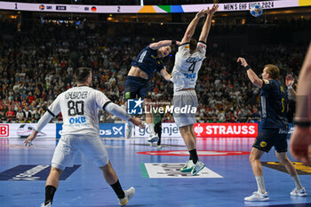 2024-01-28 - Jonathan Carlsbogard (Sweden) ina Johannes Golla (Germany) during 3rd and 4th place final of the Men’s EHF Euro 2024 match between Sweden vs Germany at the Lanxess Arena, Cologne, Germany - MEN'S EHF EURO 2024 - PLACEMENT MATCH 3/4 - SWEDEN VS GERMANY  - HANDBALL - OTHER SPORTS