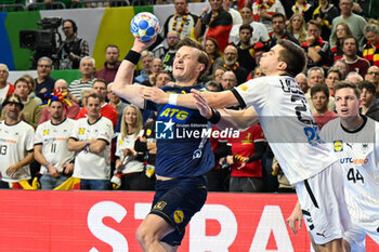 2024-01-28 - Jonathan Carlsbogard (Sweden) ina Renars Uscins (Germany) during 3rd and 4th place final of the Men’s EHF Euro 2024 match between Sweden vs Germany at the Lanxess Arena, Cologne, Germany - MEN'S EHF EURO 2024 - PLACEMENT MATCH 3/4 - SWEDEN VS GERMANY  - HANDBALL - OTHER SPORTS
