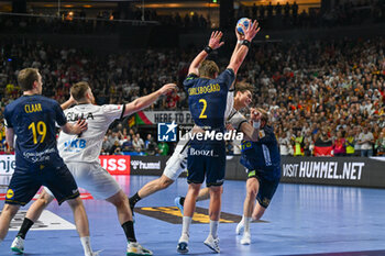 2024-01-28 - Julian Koster (Germany) in action against Jonathan Carlsbogard (Sweden) during 3rd and 4th place final of the Men’s EHF Euro 2024 match between Sweden vs Germany at the Lanxess Arena, Cologne, Germany - MEN'S EHF EURO 2024 - PLACEMENT MATCH 3/4 - SWEDEN VS GERMANY  - HANDBALL - OTHER SPORTS