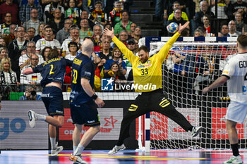2024-01-28 - Jonathan Carlsbogard (Sweden) scores a gafter scores a goal against Andreas Wolff (Germany) during 3rd and 4th place final of the Men’s EHF Euro 2024 match between Sweden vs Germany at the Lanxess Arena, Cologne, Germany - MEN'S EHF EURO 2024 - PLACEMENT MATCH 3/4 - SWEDEN VS GERMANY  - HANDBALL - OTHER SPORTS