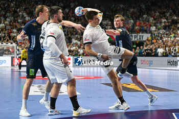 2024-01-28 - Christoph Steinert (Germany) in action against Jonathan Carlsbogard (Sweden) during 3rd and 4th place final of the Men’s EHF Euro 2024 match between Sweden vs Germany at the Lanxess Arena, Cologne, Germany - MEN'S EHF EURO 2024 - PLACEMENT MATCH 3/4 - SWEDEN VS GERMANY  - HANDBALL - OTHER SPORTS