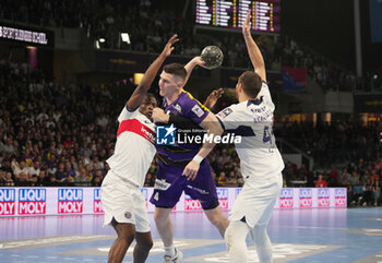 2024-04-07 - Aymeric Minne of Nantes and Wallem Peleka, Nikola Karabatic of PSG during the French championship, Liqui Moly Starligue handball match between HBC Nantes and Paris Saint-Germain on April 7, 2024 at H Arena in Nantes, France - HANDBALL - FRENCH CHAMP - NANTES V PARIS SG - HANDBALL - OTHER SPORTS