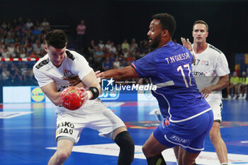 2024-05-11 - Sean CORNING of United States and Timothey N’GUESSAN of France during the International Friendly Handball match between France and United States on May 11, 2024 at LDLC Arena in Décines-Charpieu near Lyon, France - HANDBALL - FRIENDLY GAME - FRANCE V UNITED STATES - HANDBALL - OTHER SPORTS